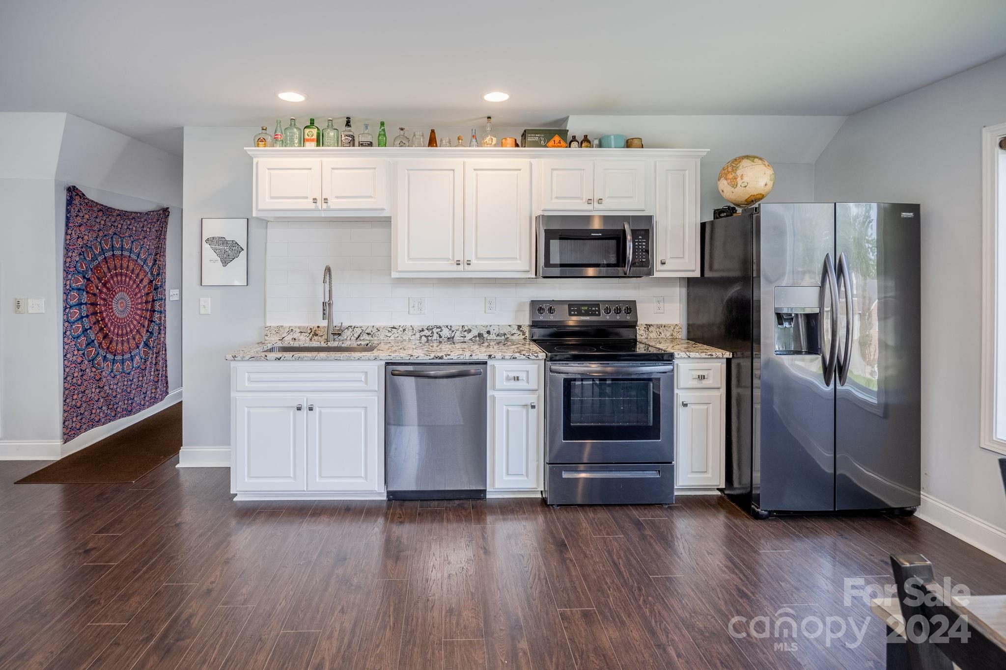 1958 Boxelder Trail Ridgeway, SC 29130 - Photo 41 of 46 a kitchen with stainless steel appliances a stove a microwave and cabinets