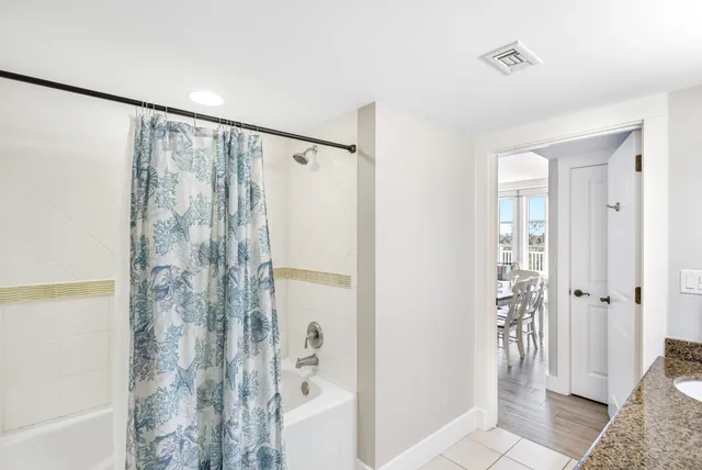a bathroom with a shower and a sink