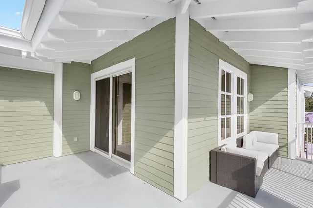 a balcony with wooden floor and fence