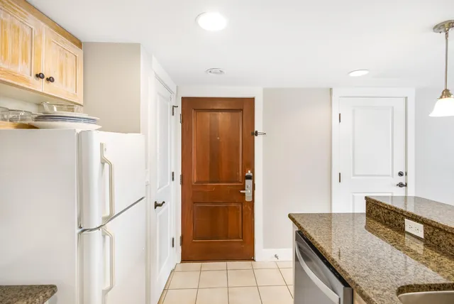a kitchen with granite countertop a refrigerator and a stove