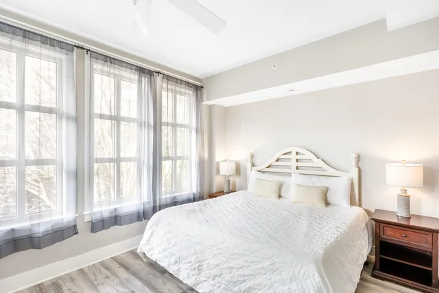 a bedroom with a large bed and a large window