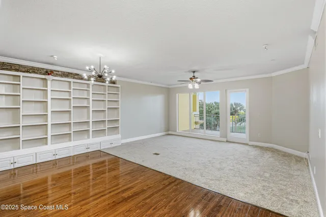 a view of a living room and kitchen with wooden floor