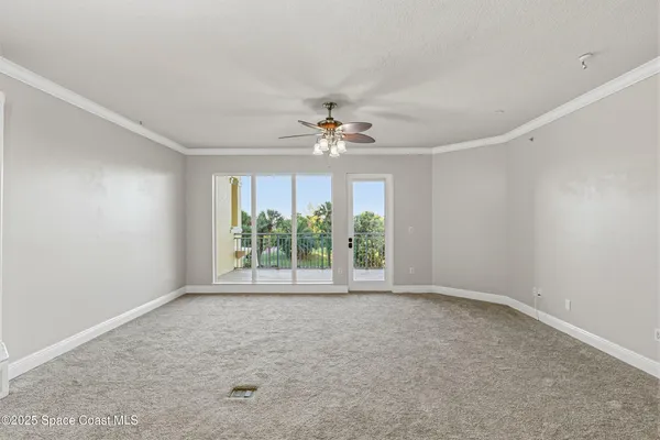 a view of a living room and kitchen with wooden floor