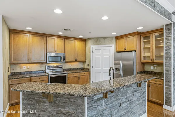 a kitchen with a sink and a stove top oven