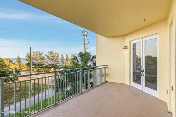a view of roof deck with table and chairs