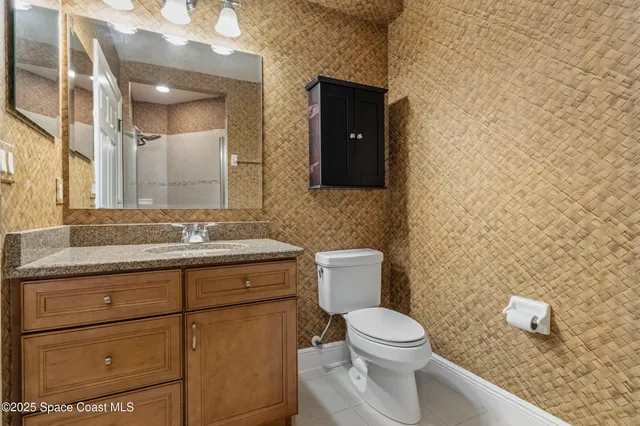 a kitchen with stainless steel appliances kitchen island granite countertop a table chairs sink and cabinets