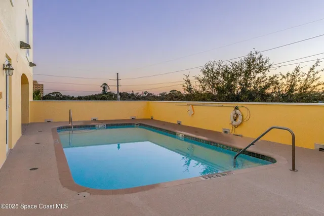 a view of a swimming pool with a patio and a garden