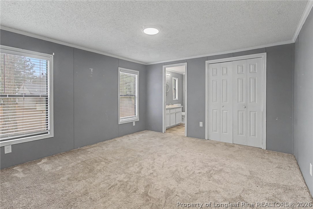 1512 Seabrook School Road Fayetteville, NC 28312 - Photo 15 of 30 a view of an empty room with closet and a window