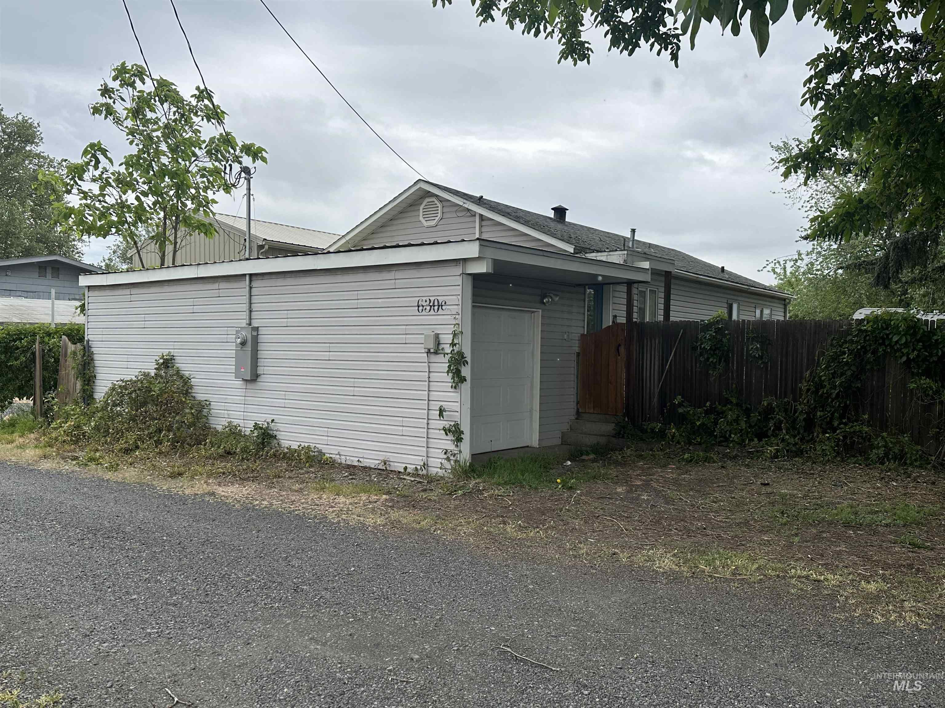630 Preston Avenue, Unit C Lewiston, ID 83501 - Photo 1 of 10 Single-story residence featuring light gray siding and a gabled roofline