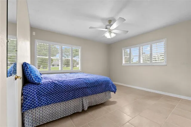 a bedroom with a large bed and a window