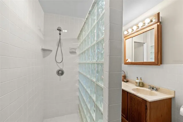 a bathroom with a sink a mirror and a shower