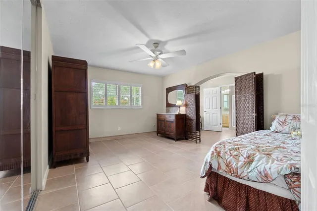 a bedroom with a bed dresser and a flat tv screen