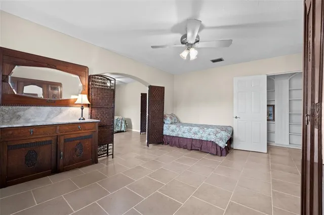 a spacious bathroom with a granite countertop sink a mirror and a bathtub