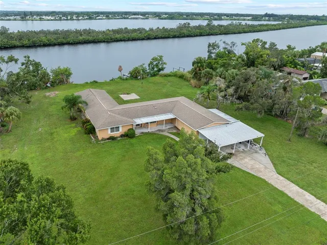 an aerial view of a house with a lake view
