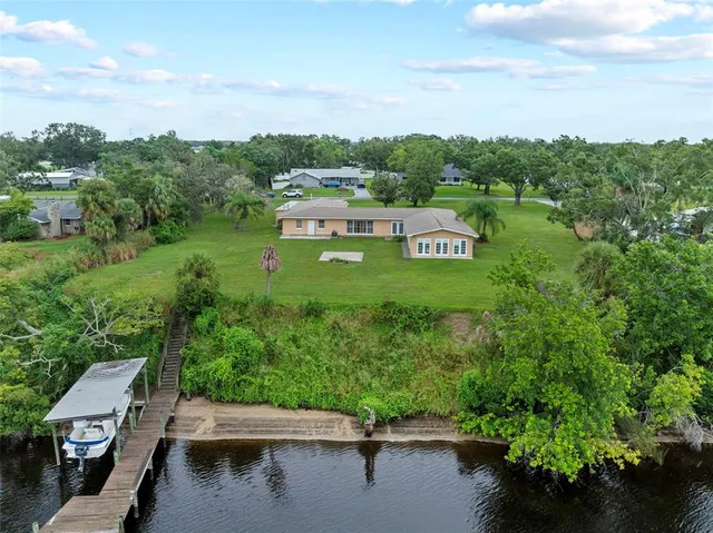 an aerial view of a house with a yard