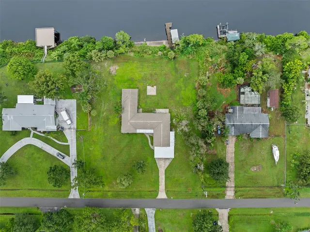 an aerial view of a houses with outdoor space swimming pool and lake view