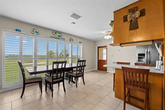 a view of a dining room with furniture and chandelier