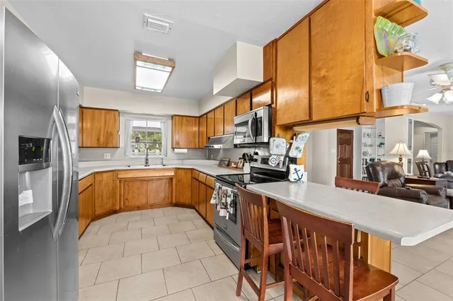 a kitchen with stainless steel appliances granite countertop a sink and a stove