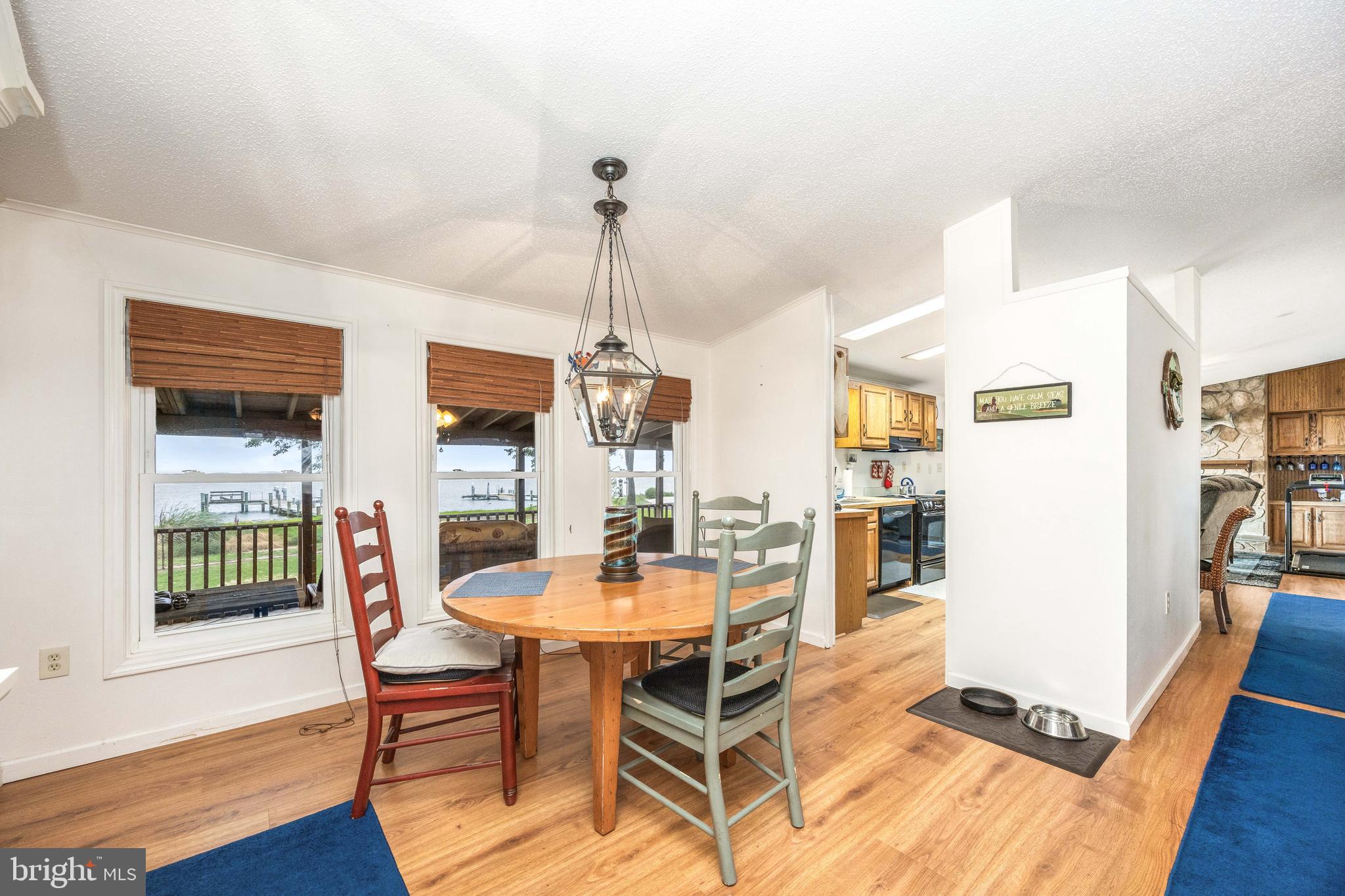 7940 Riverview Road Westover, MD 21871 - Photo 19 of 93 a dining room with furniture a chandelier and wooden floor
