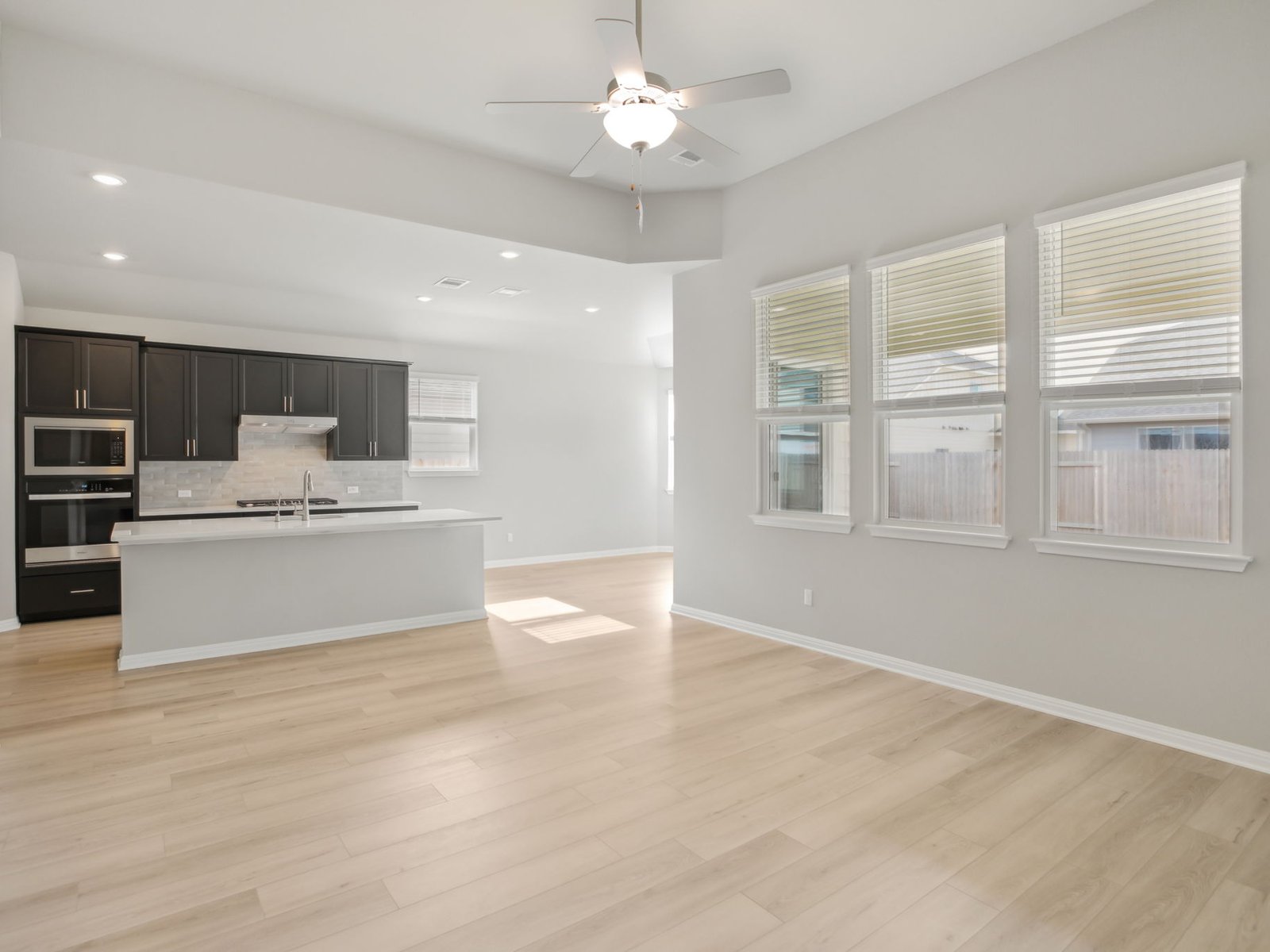 129 Pendleton Drive Kyle, TX 78640 - Photo 11 of 11 a view of kitchen with stainless steel appliances cabinets large window and wooden floor