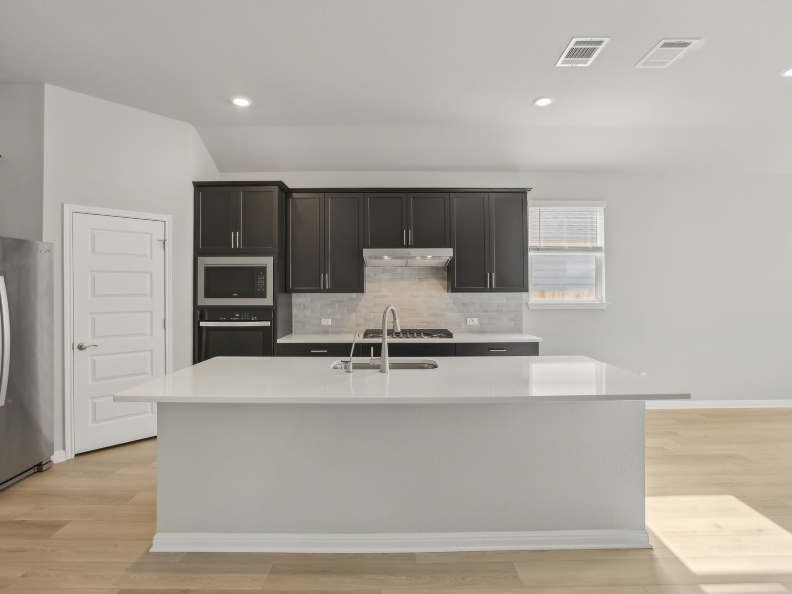 129 Pendleton Drive Kyle, TX 78640 - Photo 4 of 11 a view of a kitchen with center island and stainless steel appliances