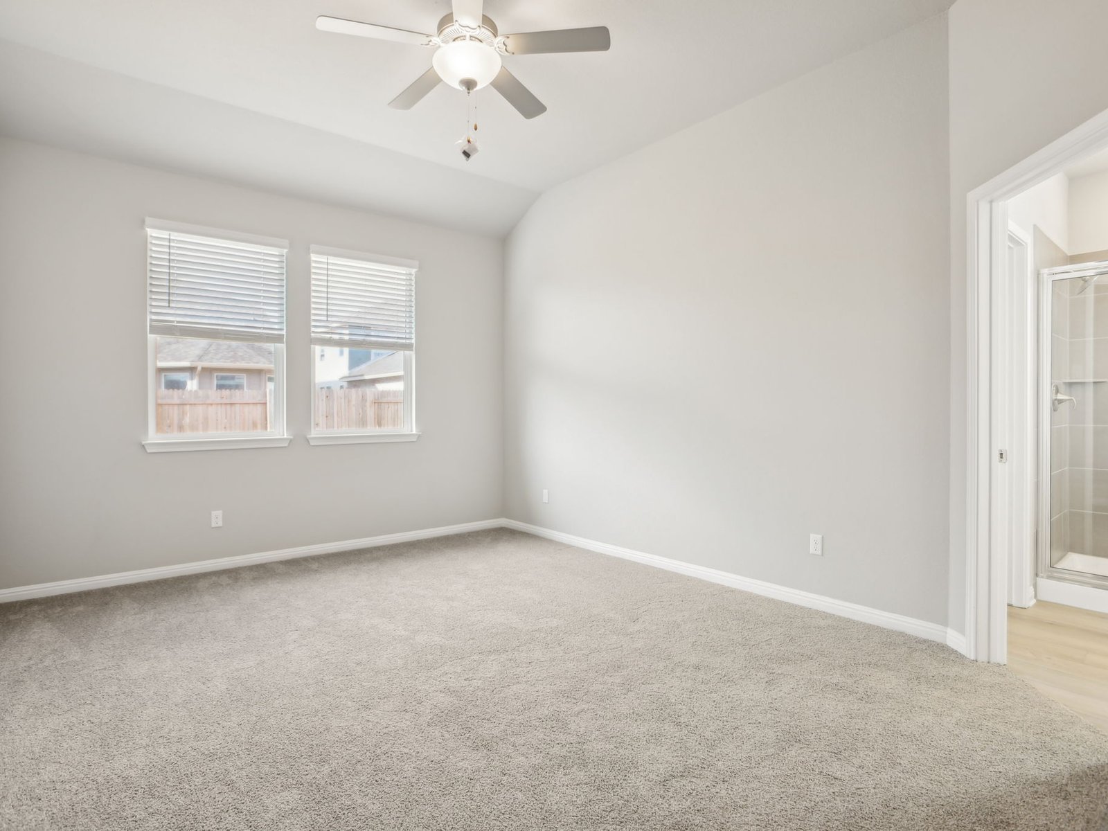129 Pendleton Drive Kyle, TX 78640 - Photo 6 of 11 an empty room with windows and fan