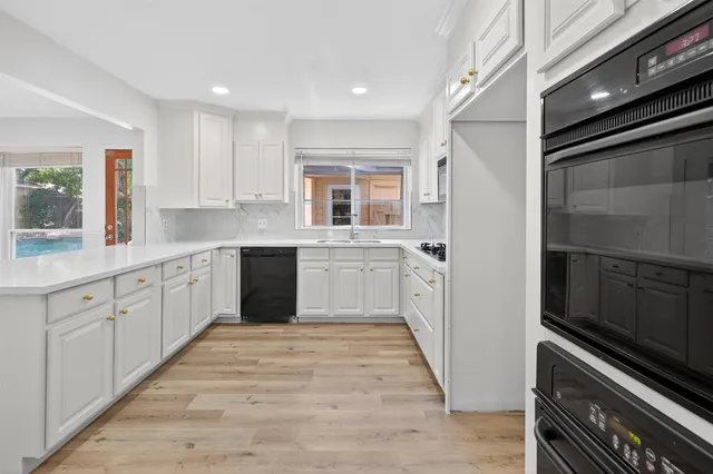 a large kitchen with a stove top oven