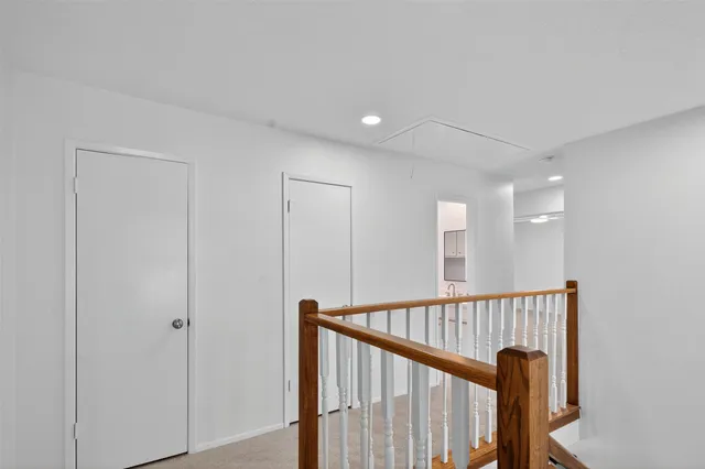 a view of a hallway with a dining room stairs