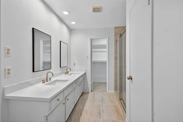 a bathroom with 2 sink double vanity and a mirror
