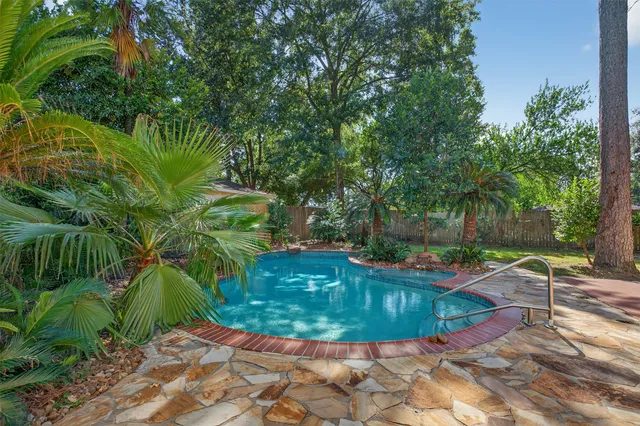 a view of a swimming pool with a patio