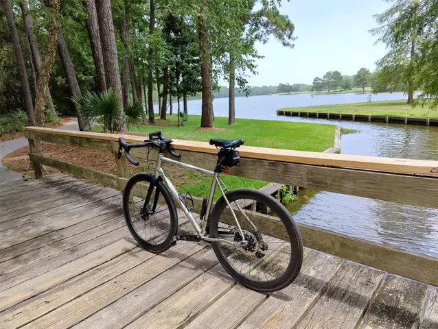 a view of a wooden deck with furniture and a lake view