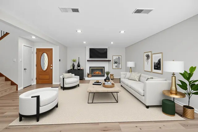 a living room with furniture fireplace and a flat screen tv