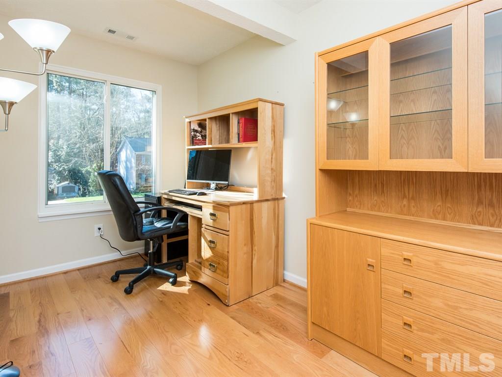 115 Trinity Woods Drive Raleigh, NC 27607 - Photo 13 of 25 a view of a workspace with furniture and a window
