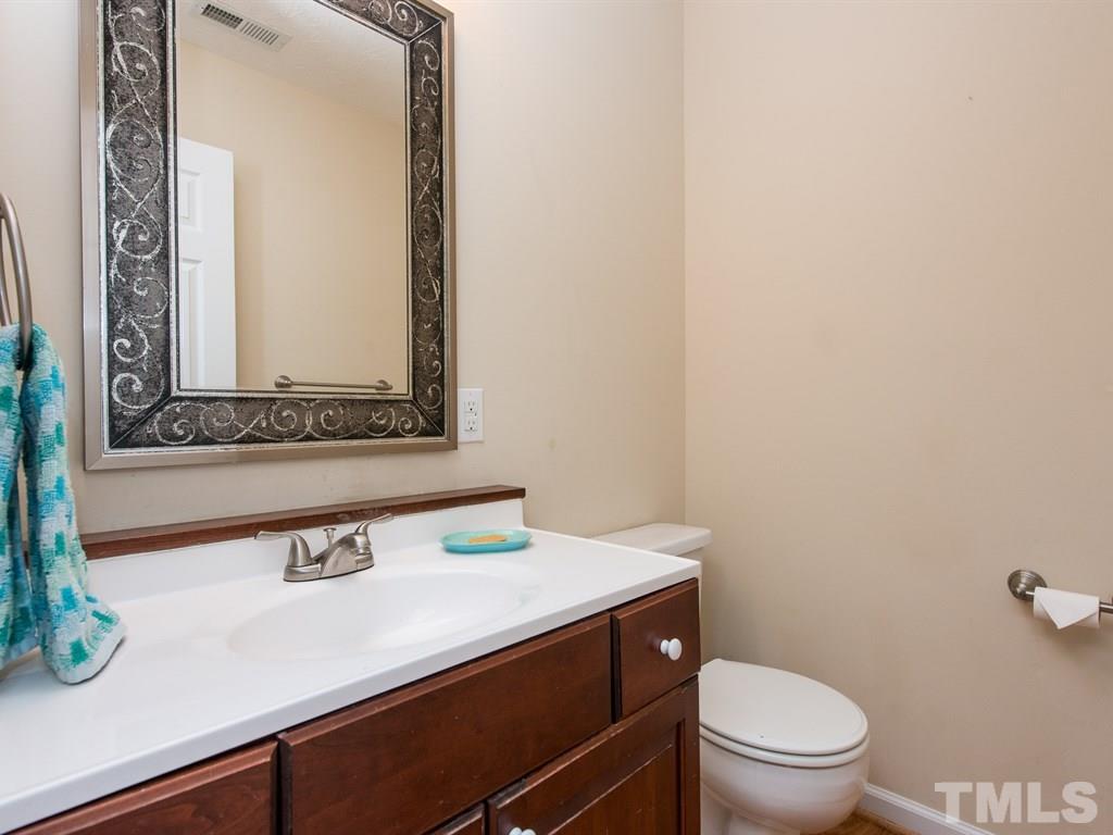 115 Trinity Woods Drive Raleigh, NC 27607 - Photo 14 of 25 a bathroom with a sink a toilet and mirror