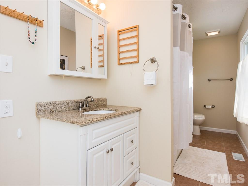 115 Trinity Woods Drive Raleigh, NC 27607 - Photo 16 of 25 a bathroom with a granite countertop sink toilet and shower