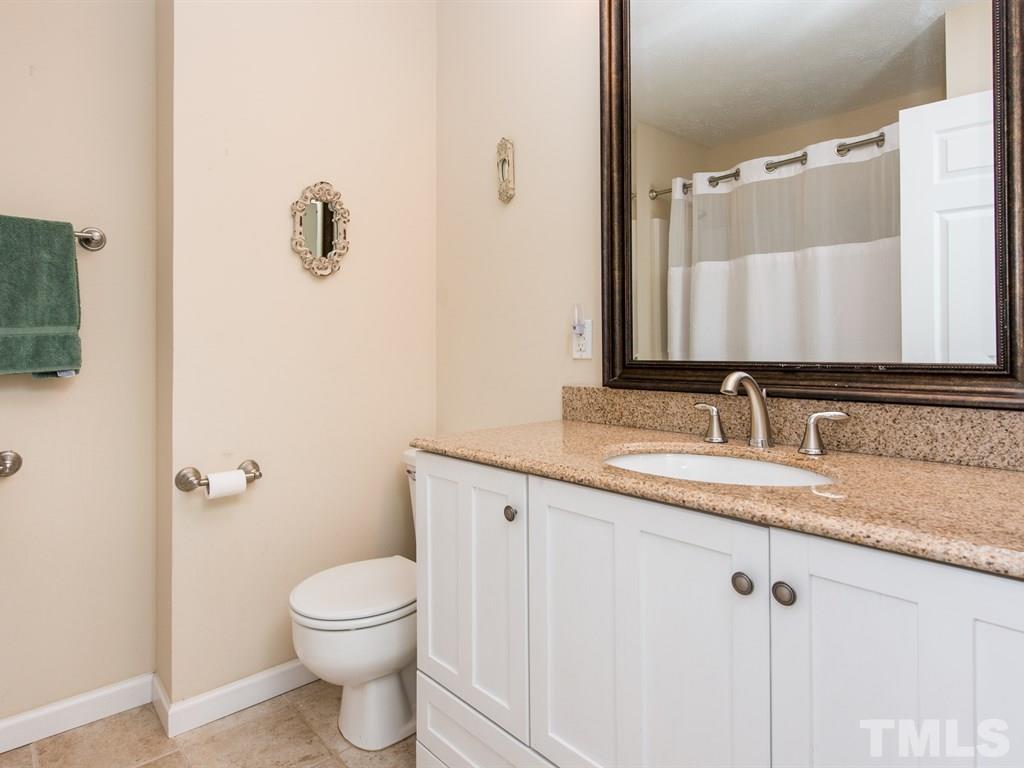115 Trinity Woods Drive Raleigh, NC 27607 - Photo 18 of 25 a bathroom with a granite countertop sink toilet and mirror