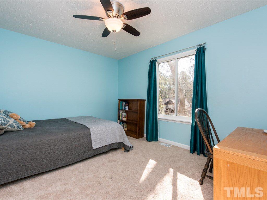115 Trinity Woods Drive Raleigh, NC 27607 - Photo 19 of 25 a bedroom with a bed and a window