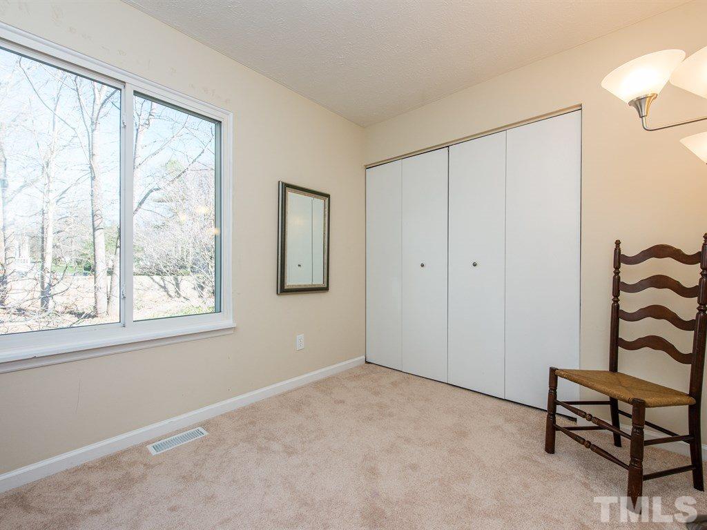 115 Trinity Woods Drive Raleigh, NC 27607 - Photo 20 of 25 a view of an empty room with a window