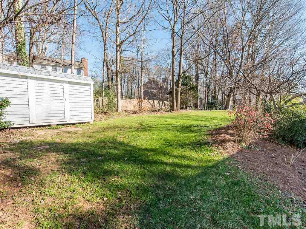 115 Trinity Woods Drive Raleigh, NC 27607 - Photo 24 of 25 a backyard of a house with lots of green space