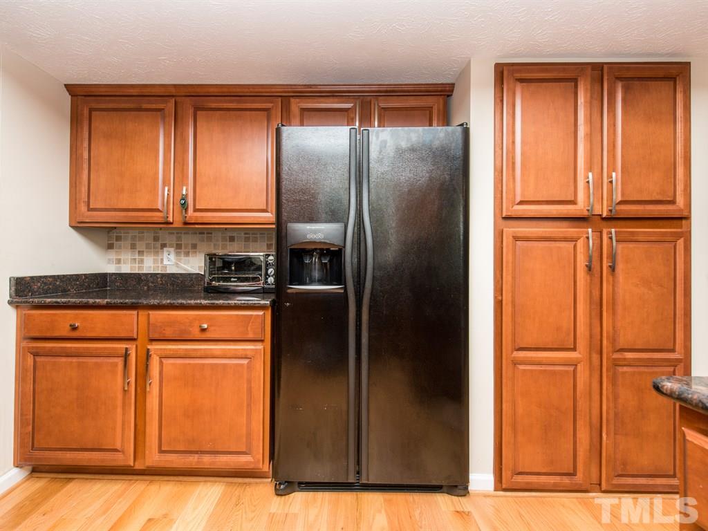 115 Trinity Woods Drive Raleigh, NC 27607 - Photo 5 of 25 a kitchen with stainless steel appliances granite countertop a refrigerator and a sink