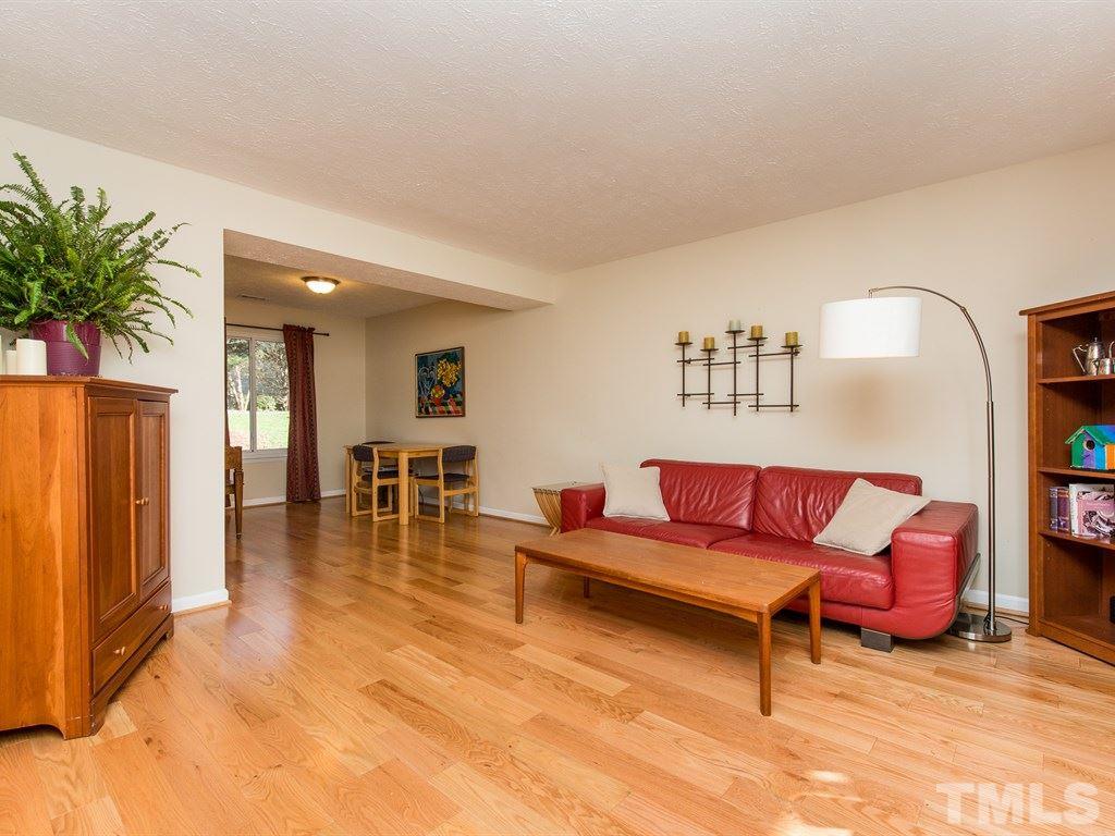 115 Trinity Woods Drive Raleigh, NC 27607 - Photo 7 of 25 a living room with furniture and wooden floor