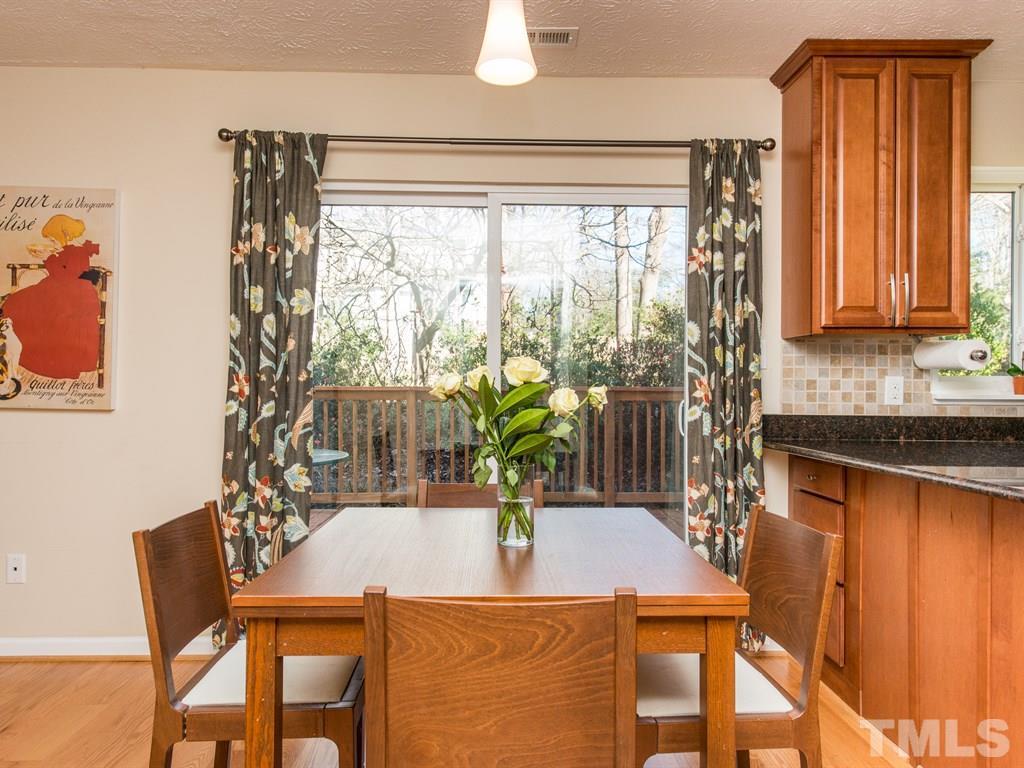 115 Trinity Woods Drive Raleigh, NC 27607 - Photo 10 of 25 a kitchen with a table and chairs