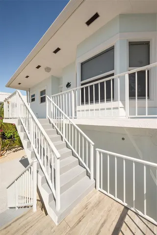 a living room with furniture and a view of kitchen