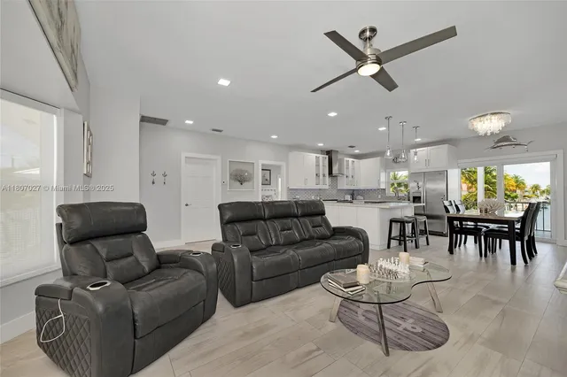 a kitchen with white cabinets and sink