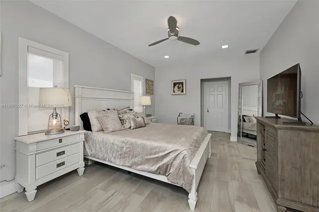 a bathroom with a granite countertop sink a toilet and shower