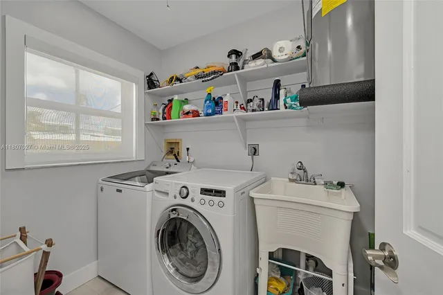 a dining room with wooden floor a chandelier a glass table and chairs