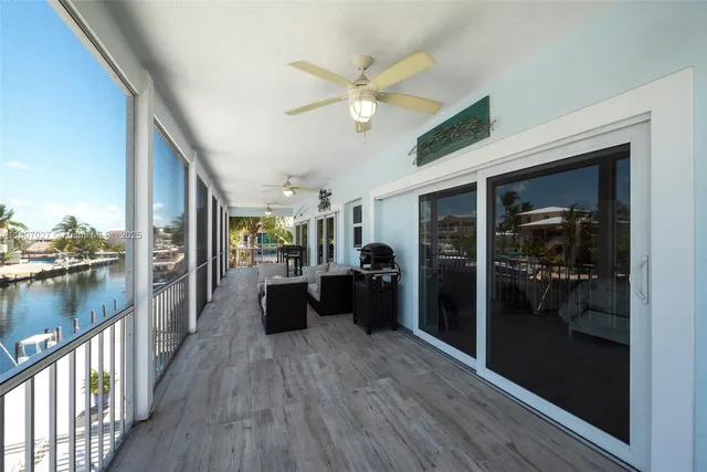 a view of a hallway with wooden floor and closet