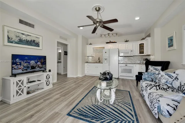 a view of a patio with table and chairs potted plants
