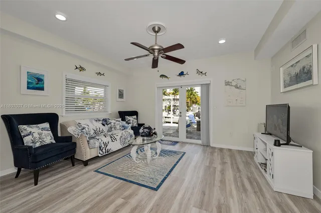 a view of a patio with table and chairs potted plants