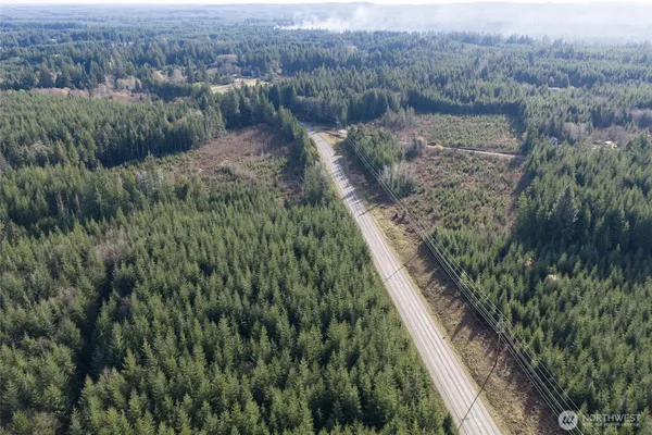 a view of a road with trees in the background